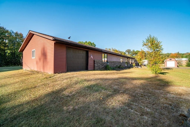 view of property exterior with a lawn and an outbuilding