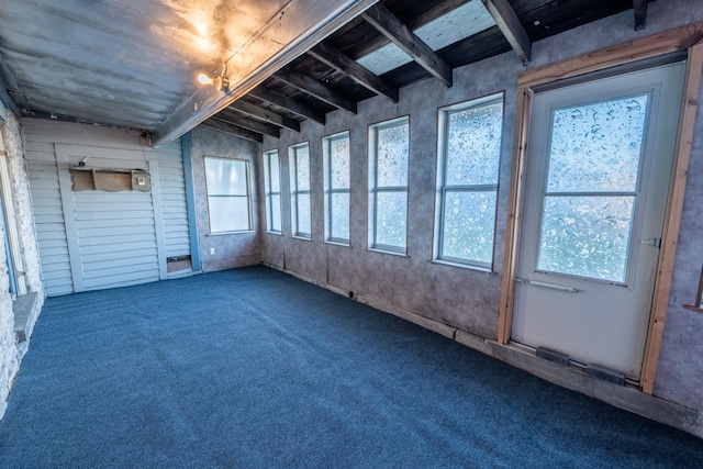 unfurnished sunroom with beamed ceiling