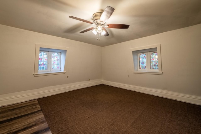 unfurnished room with ceiling fan and dark hardwood / wood-style flooring