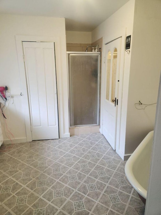 bathroom with independent shower and bath and tile patterned floors