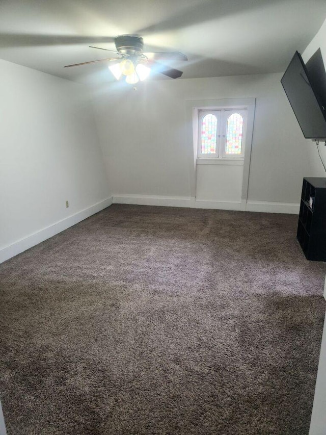 bonus room with ceiling fan and carpet flooring