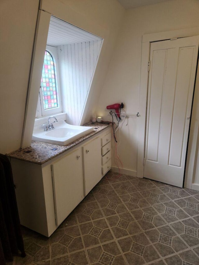 kitchen featuring sink and white cabinets