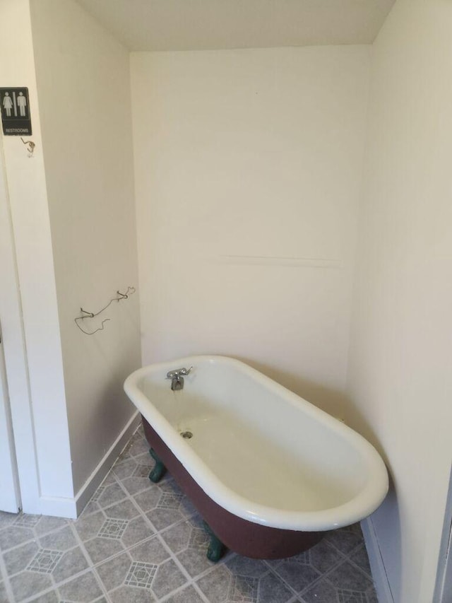 bathroom with a tub and tile patterned flooring