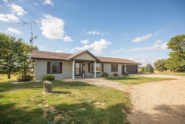 ranch-style house featuring a front yard and a garage