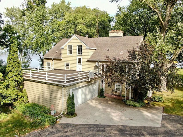 exterior space featuring a garage and a balcony