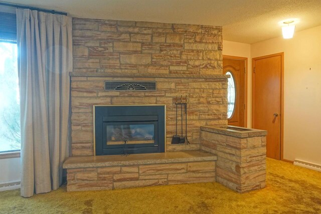 room details featuring a baseboard heating unit, carpet, a textured ceiling, and a stone fireplace