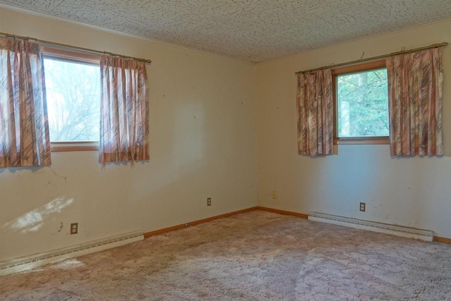 carpeted spare room with a textured ceiling and baseboard heating