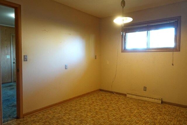 empty room featuring a baseboard heating unit