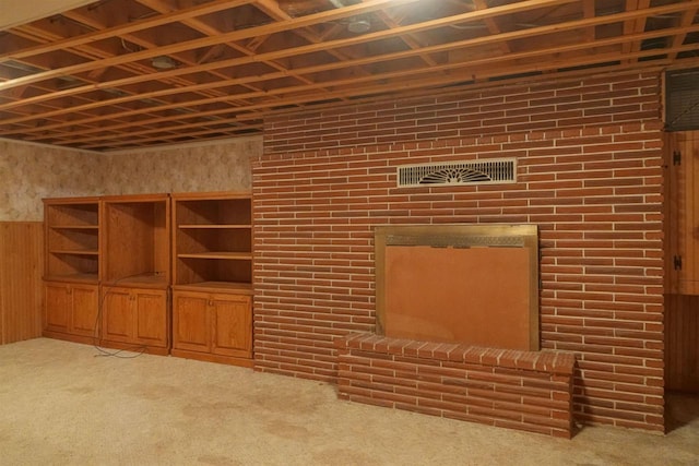 unfurnished living room with light carpet and wood walls