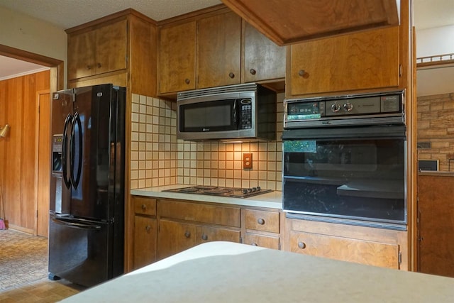 kitchen featuring black appliances and tasteful backsplash