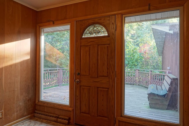 entryway featuring ornamental molding, wooden walls, and baseboard heating