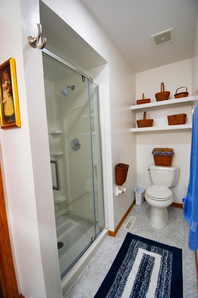 bathroom with a shower with shower door and toilet