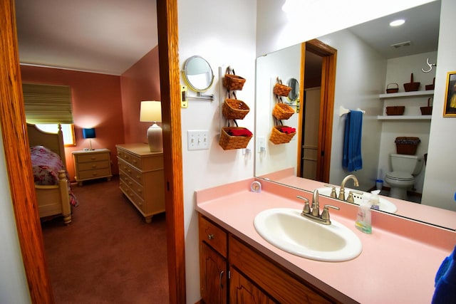 bathroom featuring vanity and toilet