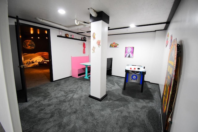 playroom featuring dark colored carpet