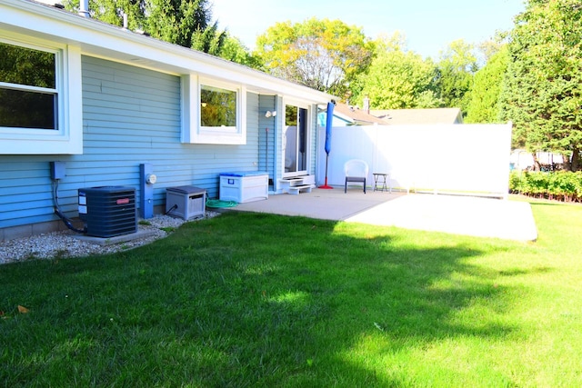 back of house featuring a patio, central air condition unit, and a yard