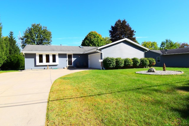 ranch-style house featuring a garage and a front lawn