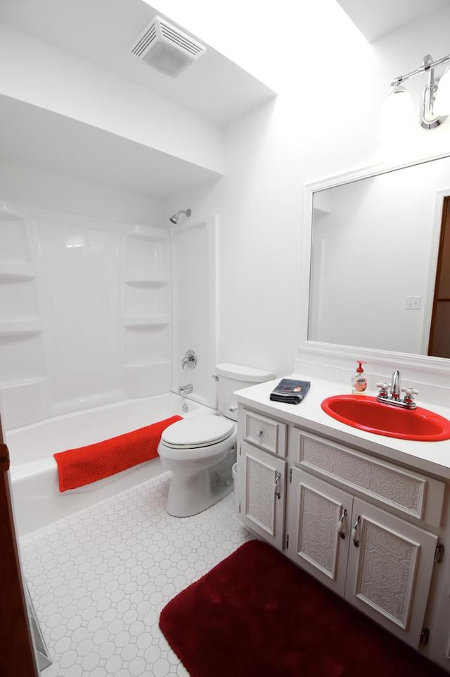 full bathroom featuring vanity, bathing tub / shower combination, and toilet