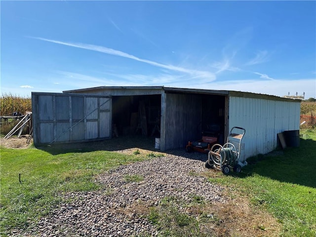 view of outdoor structure featuring a lawn