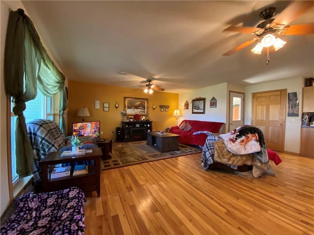 living room featuring ceiling fan and light wood-type flooring