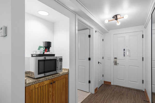 interior space with wood-type flooring and crown molding