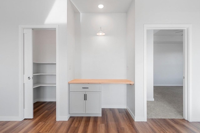 corridor with dark hardwood / wood-style flooring