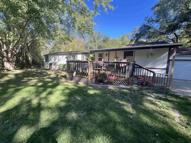 650 Roosevelt St, Mauston, WI 53948 - back of property with a yard and a deck