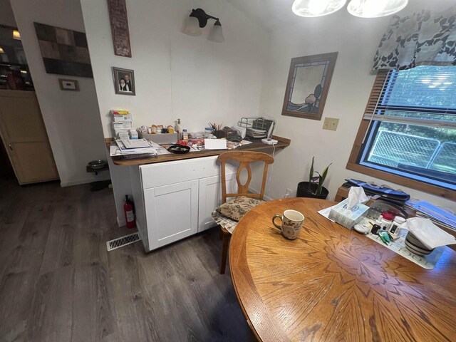 650 Roosevelt St, Mauston, WI 53948 - dining space with dark wood finished floors and visible vents