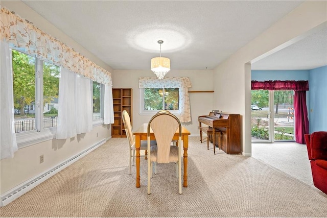 dining room featuring carpet floors, a healthy amount of sunlight, a textured ceiling, and a baseboard radiator