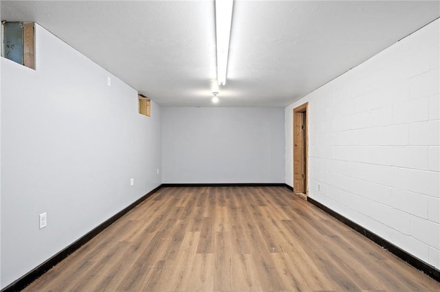 basement with hardwood / wood-style floors and a textured ceiling