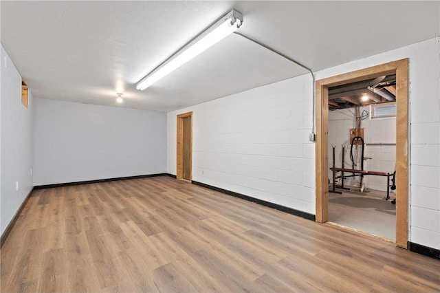 basement with light hardwood / wood-style floors