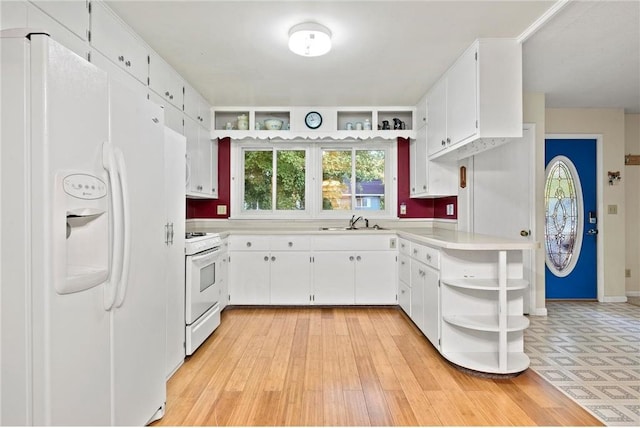 kitchen with sink, white cabinets, light hardwood / wood-style flooring, and white appliances