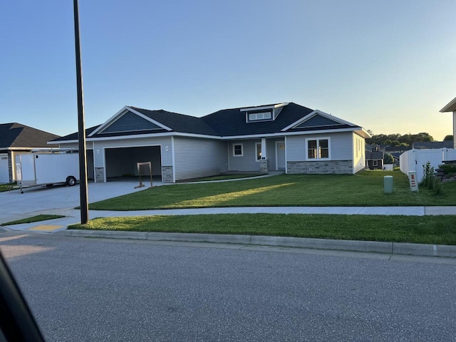 view of front of property with a yard and a garage