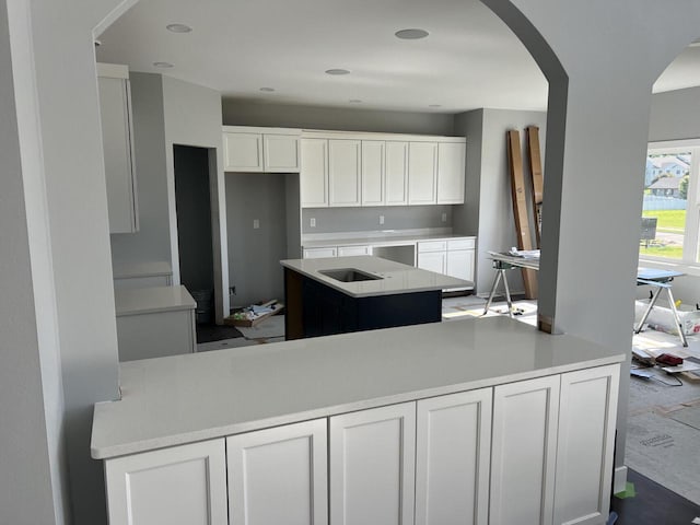 kitchen featuring white cabinets and a center island