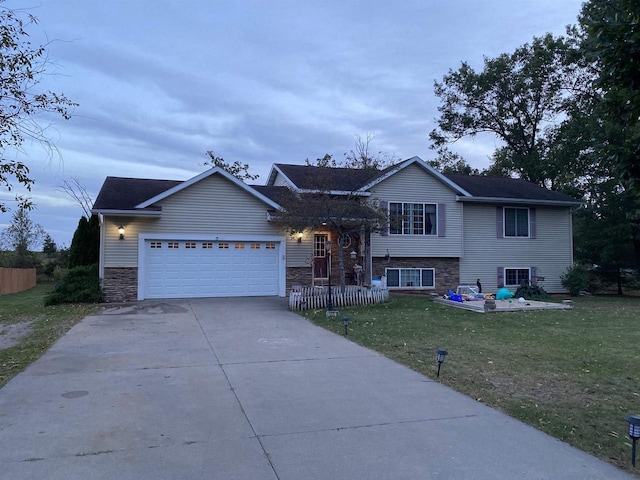 view of front of home with a front lawn and a garage