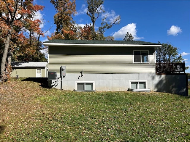 view of home's exterior with a lawn and a wooden deck