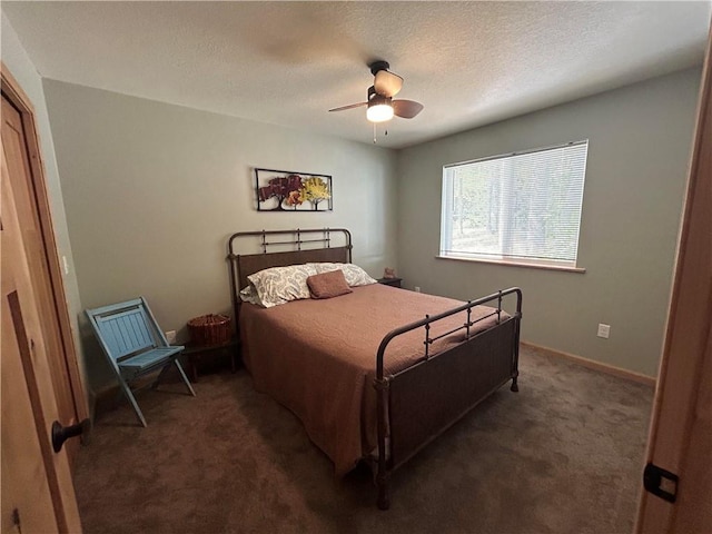 carpeted bedroom featuring a textured ceiling and ceiling fan