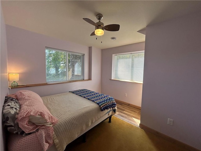 bedroom with ceiling fan and light hardwood / wood-style flooring