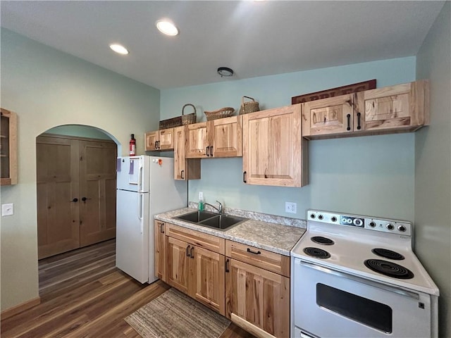 kitchen featuring light brown cabinetry, white appliances, dark hardwood / wood-style flooring, and sink