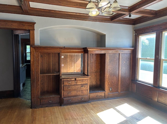 interior space featuring light hardwood / wood-style floors, coffered ceiling, an inviting chandelier, and beamed ceiling