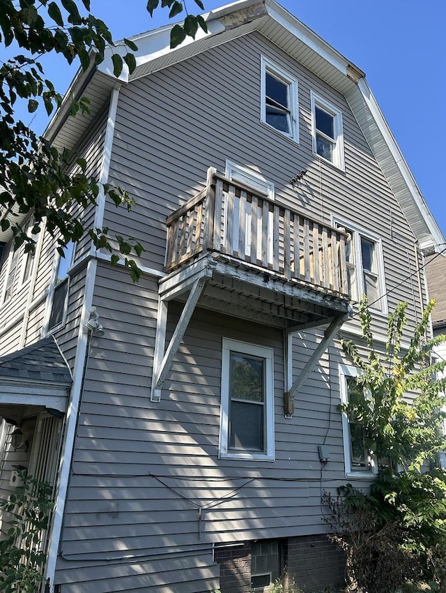 view of side of home with a balcony