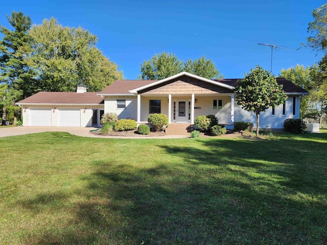 single story home featuring a front yard, a porch, and a garage