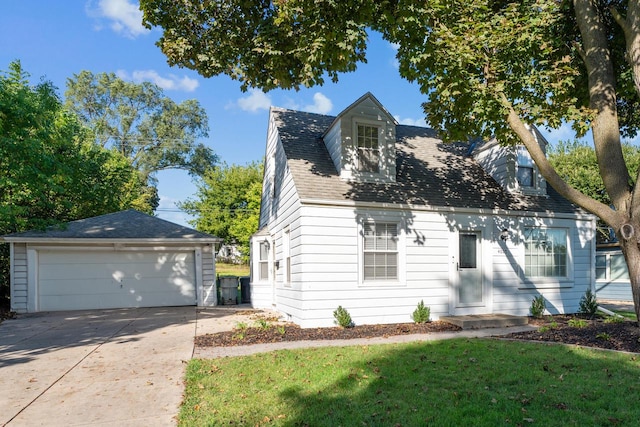 cape cod home with an outbuilding, a garage, and a front yard