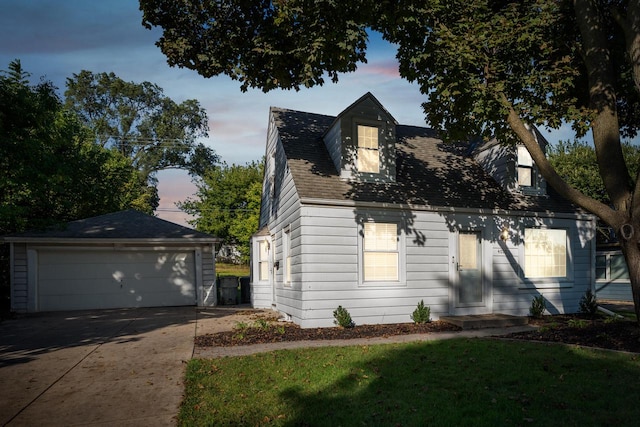 view of front of home with a lawn, an outbuilding, and a garage