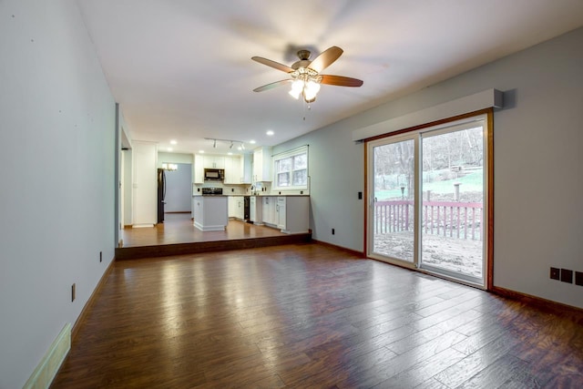 unfurnished living room featuring wood-type flooring and ceiling fan