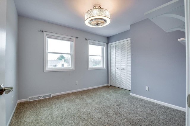 unfurnished bedroom with a closet and carpet