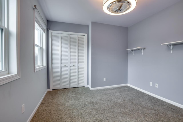 unfurnished bedroom with a closet and carpet