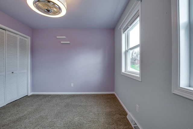 unfurnished bedroom with a closet and carpet flooring