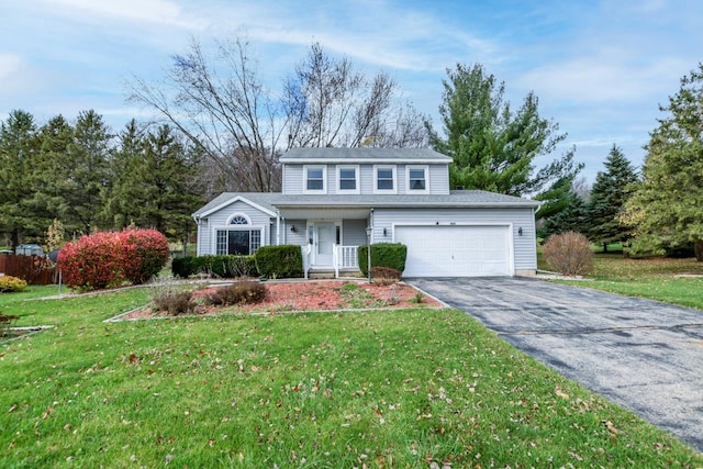 view of front property featuring a front lawn, a garage, and a porch