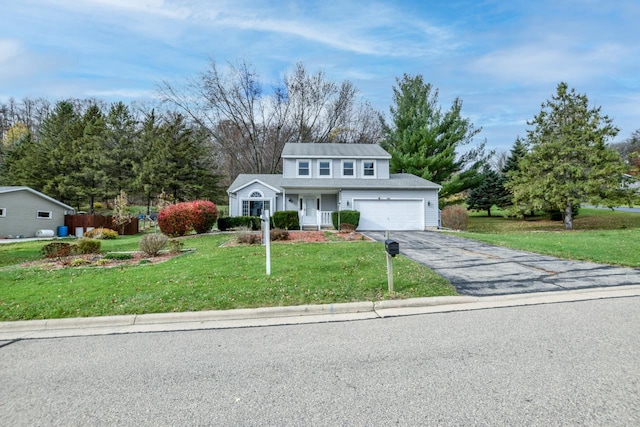 view of property featuring a front lawn and a garage