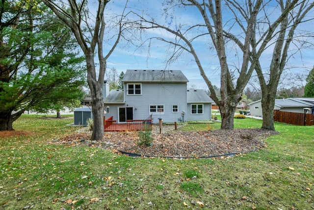 back of house with a lawn and a wooden deck